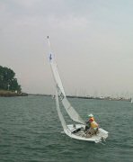 Ken and Beth sailing out of Waukegan Harbor on JY15 for Saturday regatta